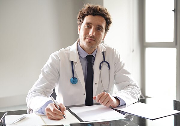 Male medical professional at his desk