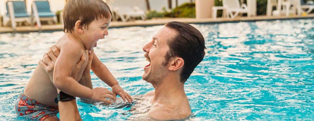 Father and toddler swimming
