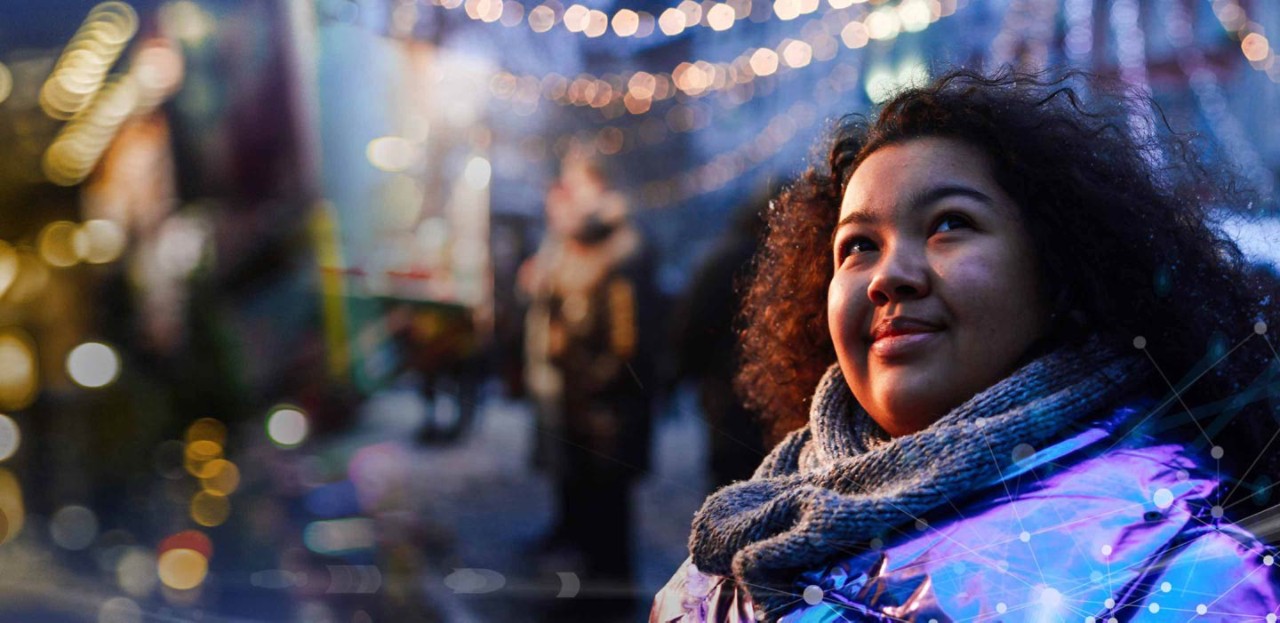 Photo of a woman outdoors at a winter fair in a city.